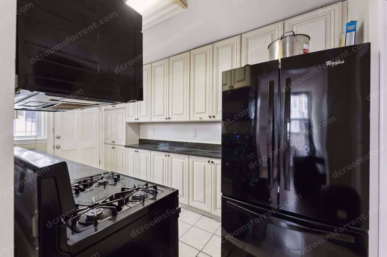 Shared kitchen from the entry: full galley view with stove and fridge