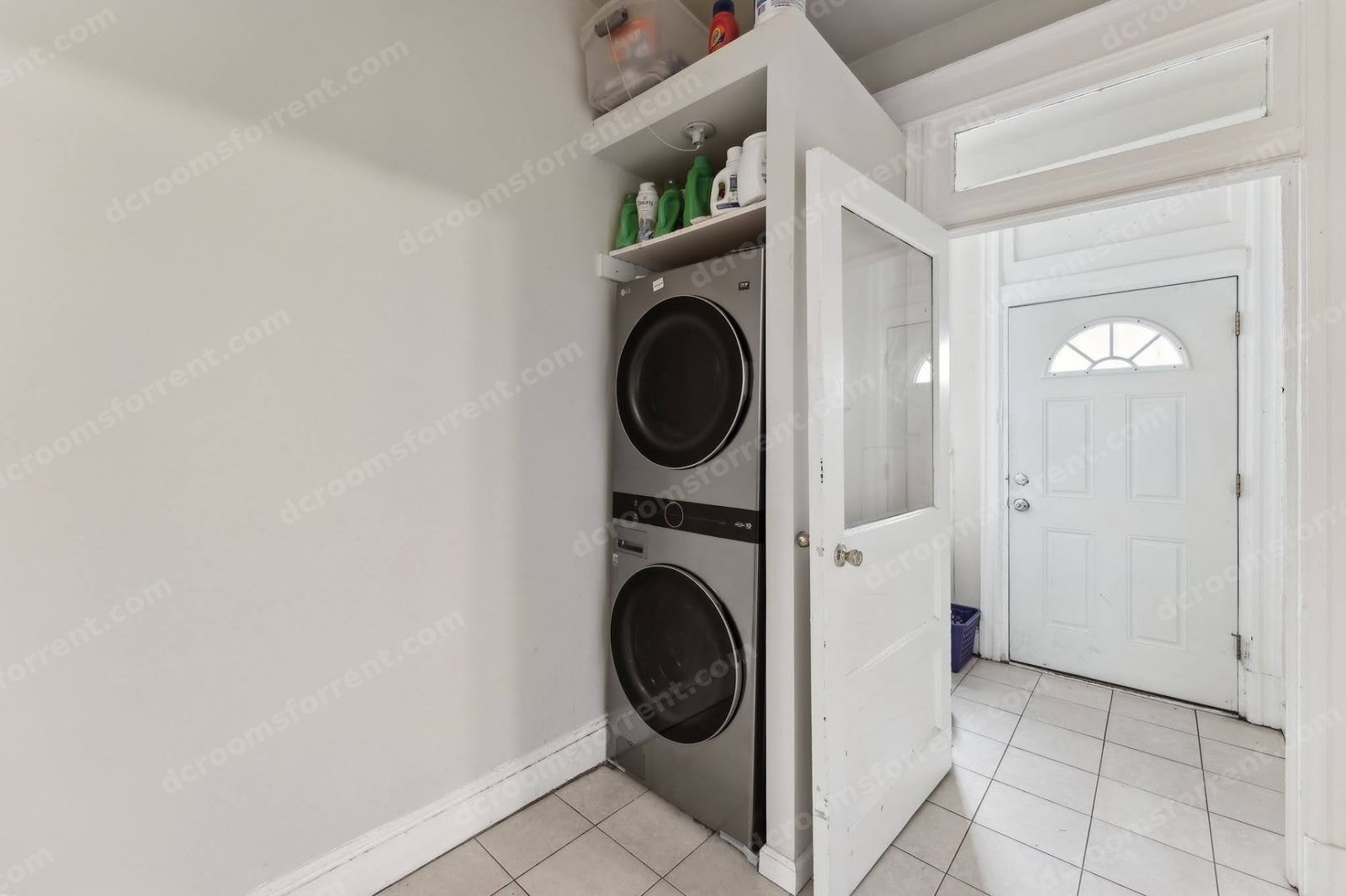 Shared laundry: stacked washer and dryer by the entry door