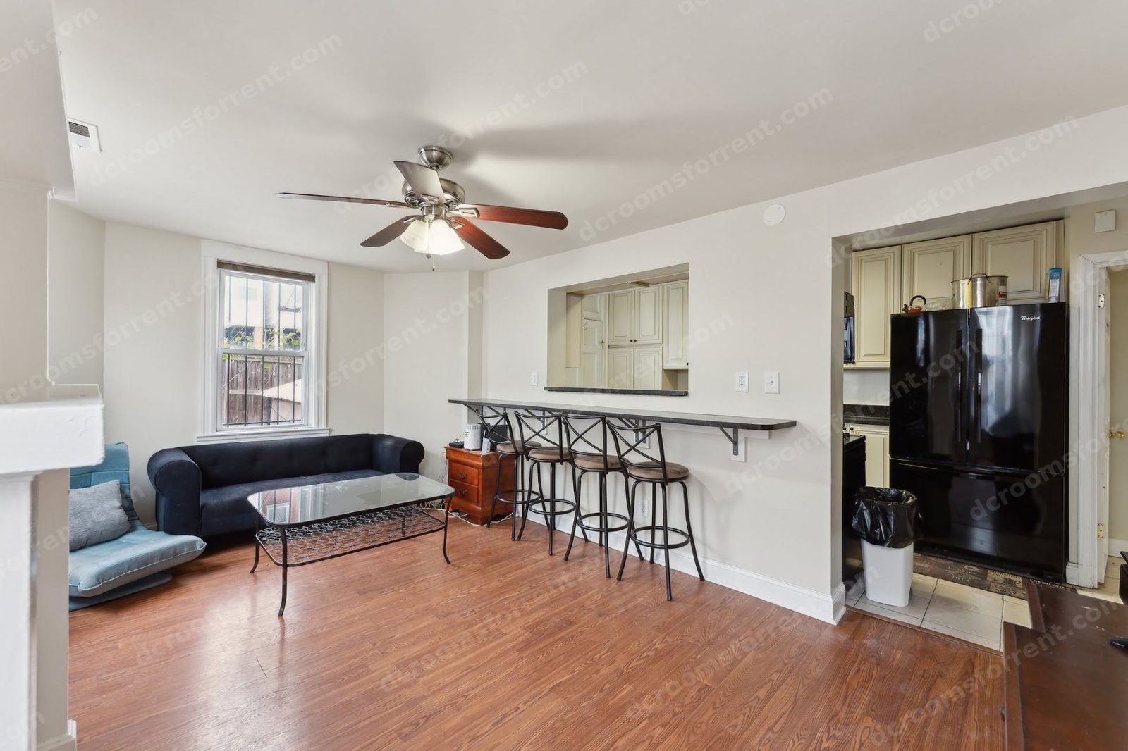 Shared living room: bar counter with stools, open to the kitchen
