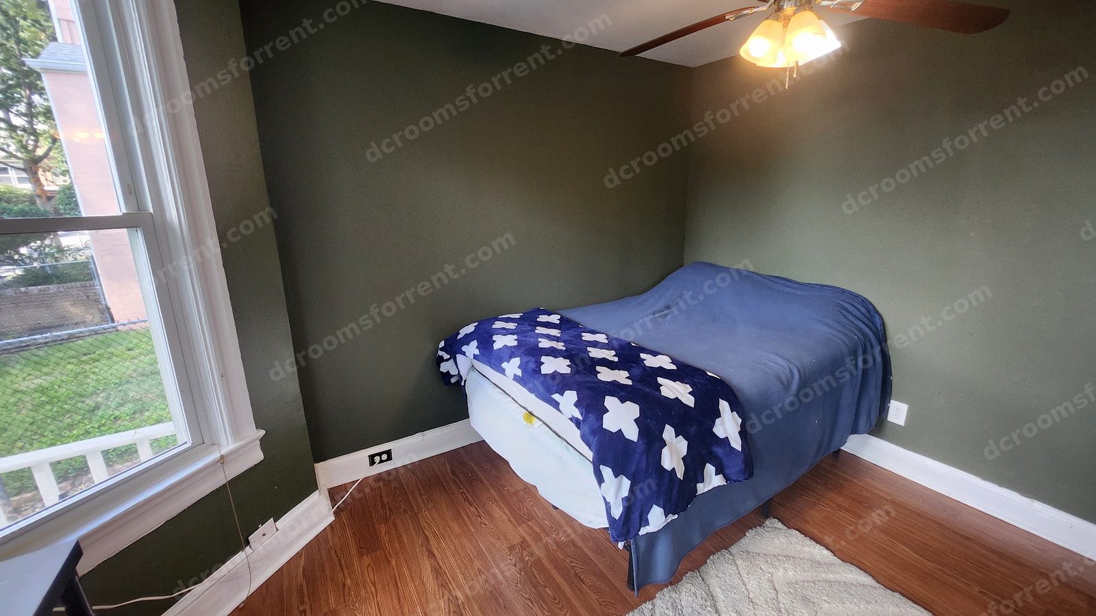 Delta Room: bed in the corner with window view of the backyard