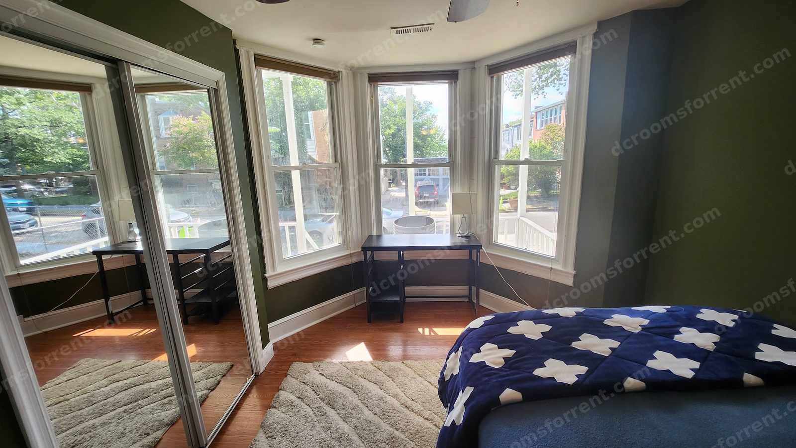 Delta Room: bed with ceiling fan and mirrored closet reflection