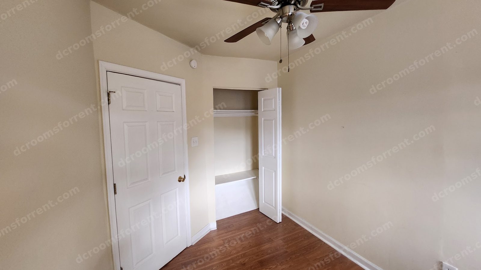 Foxtrot Room: built-in closet with open door, shelf and hanging rod