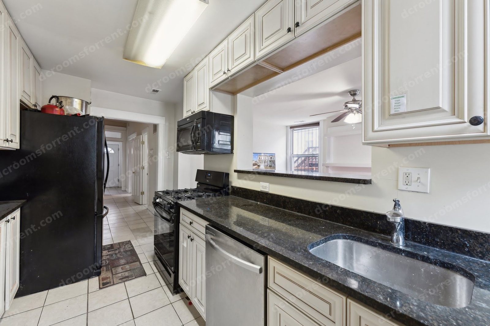 Marlboro house shared kitchen: sink, dishwasher, and pass-through to the living room