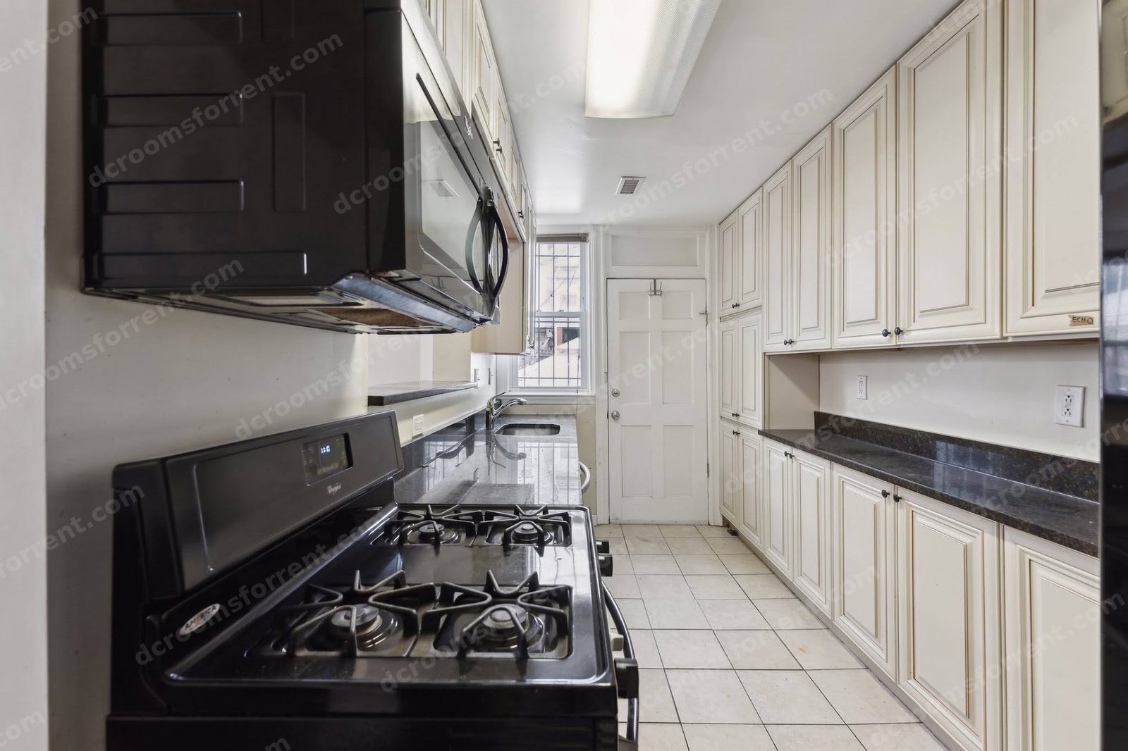 Marlboro house shared kitchen: gas stove, microwave, and white cabinets