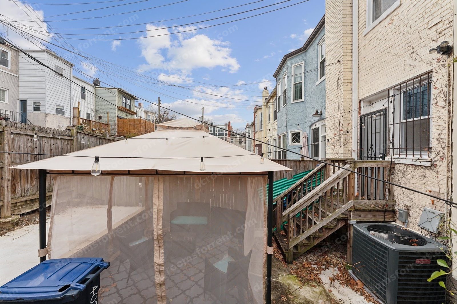 Marlboro house shared patio: gazebo with string lights, wood deck, and fenced yard